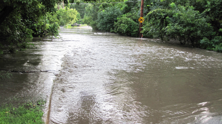 Walnut Creek flows over North Valley Drive in Des Moines after heavy rain in July 2010. Photo by Stefanie Bond.