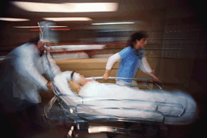 Photo of patient being rushed on a gurney