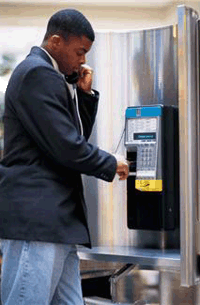 Photo of a man on a payphone
